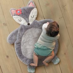 a baby is playing with a stuffed animal