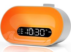 an orange alarm clock with the time on it's display is shown in front of a white background