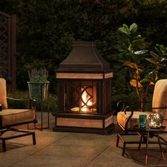 an outdoor fireplace with chairs around it