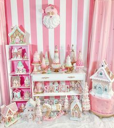 a pink and white striped room filled with lots of dollhouse accessories on shelves next to a wall