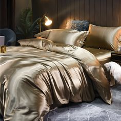 a bed with gold sheets and pillows in a room