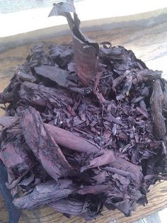 a pile of wood shavings sitting on top of a wooden table