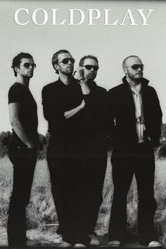 four men standing in front of a black and white photo with the words coldplay on it