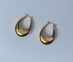 These elongated hoop earrings are a gorgeous, modern take in the classic hoop. They have a gorgeous chunky feel to them and yet are so lightweight and wearable for every day. - length approx 3cm, widest point approx 2.2cm - tarnish-free - hypoallergenic - stainless steel - 18k gold plated - super lightweight Golden Earrings Aesthetic, Trending Earrings, Cute Ear Piercings, Big Hoop Earrings, Earring Trends, Gold Bracelet Cuff