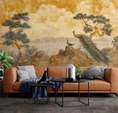 a living room scene with a couch, table and wall mural in the background that has birds on it