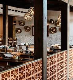 the interior of a restaurant with wooden tables and chairs, plates and utensils