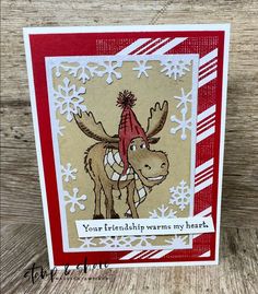 a card with a moose wearing a red hat and scarf on it's head