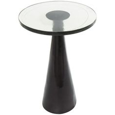 a small black table with a glass top on it's base and an oval design in the center