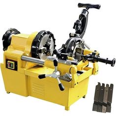 a machine that is sitting on top of a yellow box with tools in front of it