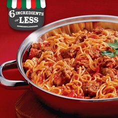 a large metal pan filled with spaghetti and meat