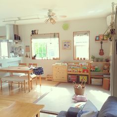 a living room filled with furniture and lots of windows