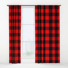 a red and black plaid curtain hanging in front of a window with the curtains open