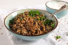 two bowls filled with food on top of a table