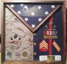 an army flag and medal display in a wooden frame