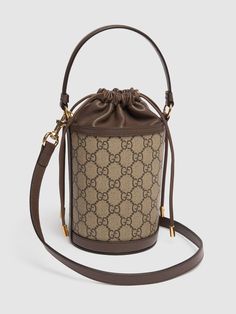 Height: 20cm Width: 11.5cm Depth: 8cm. Weight: approx. 0.3kg. Strap drop: 53.5cm. Top handle drop: 10cm. Adjustable detachable strap. Single top handle. Drawstring closure. Logo details. All over pattern placement may vary. Gold-colored metal hardware. Leather trim Gucci Bucket Bag, Canvas Bucket Bag, Gucci Mini, Gucci Ophidia, All Over Pattern, Metal Hardware, Leather Trim, Leather Trims, Top Handle