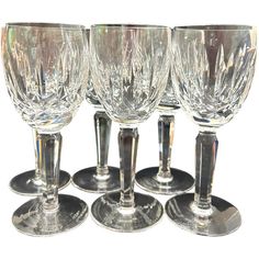 six crystal wine goblets sitting next to each other