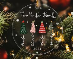 a glass ornament hanging from a christmas tree with the words, the smith family