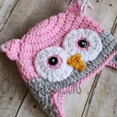 a crocheted pink and gray owl hat