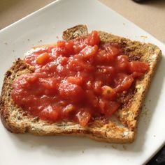 a piece of bread with tomato sauce on it