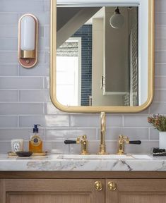 a bathroom sink with a large mirror above it