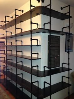 the shelves are made out of metal pipes