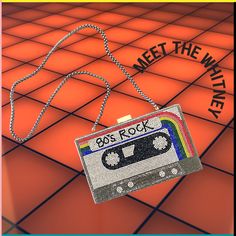 a necklace with a cassette on it that says, meet the winter 80s's rock