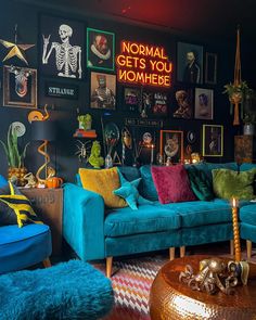 a living room filled with blue couches and colorful pillows on top of each other