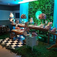 a room filled with lots of tables covered in food and decorations on top of checkered flooring