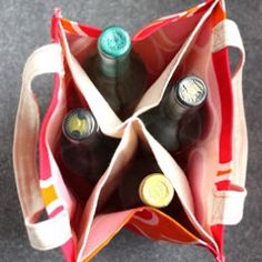 two bottles of wine are in an open bag