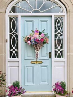 a blue front door with flowers on it