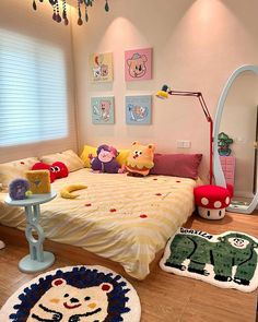 a child's bedroom decorated in pink, yellow and blue with animal rugs on the floor