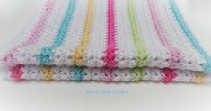 several crocheted squares are stacked together on top of each other in different colors