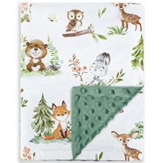 a blanket with animals on it and a green triangle hanging from the bottom of it