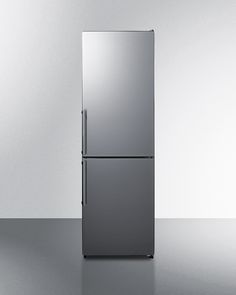 a silver refrigerator freezer sitting on top of a counter next to a white wall