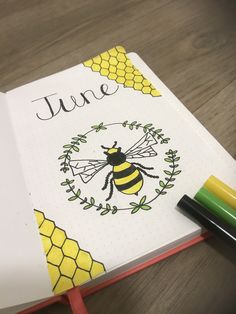 an open notebook with a bee on it