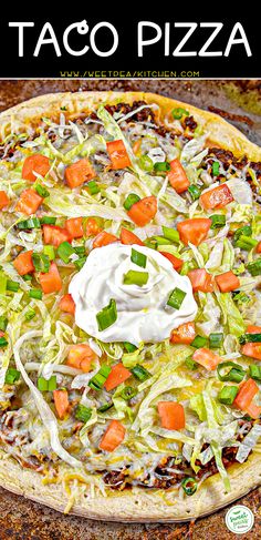 a homemade taco pizza with sour cream on top