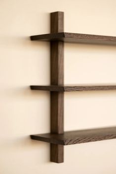 three wooden shelves mounted to the wall