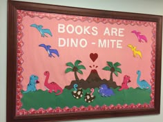 a bulletin board that says books are dino - mite with dinosaurs and palm trees