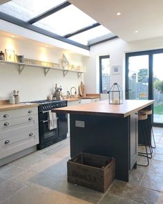 a kitchen with an island in the middle and lots of counter space on the other side