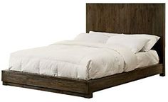 the bed is made with white linens and wood headboard, along with pillows