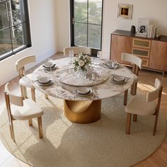 a dining room table with chairs around it and a rug on the floor next to it