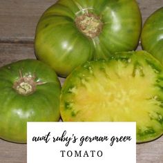 four green tomatoes sitting on top of a wooden table next to a white sign that says, any ugly's grown green tomato