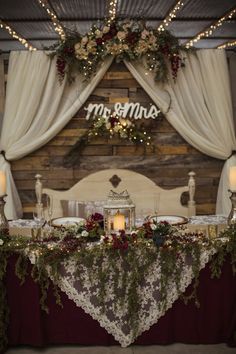 the table is set with candles and flowers for an elegant wedding reception at mr & mrs amana