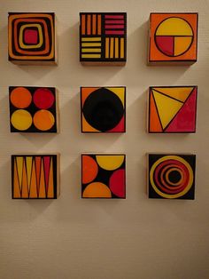 nine abstract paintings are displayed on the wall