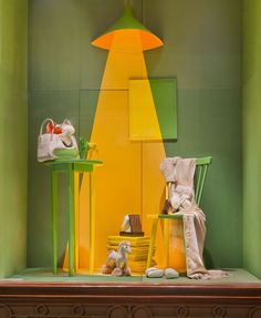 an assortment of shoes and accessories on display in a room that is green with yellow accents