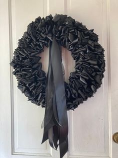 a black wreath hanging on the front door