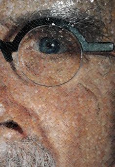 a man with glasses and a beard is depicted in this mosaic