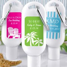 three personalized bottle openers with beach scene and starfish on the table next to them