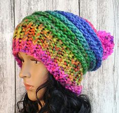 a mannequin head wearing a multicolored knitted hat