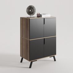 a black and brown cabinet with some books on top